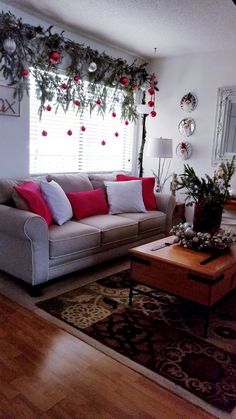 a living room filled with furniture and christmas decorations