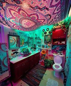 the bathroom is decorated in pink, blue and green colors with lots of lights on the ceiling