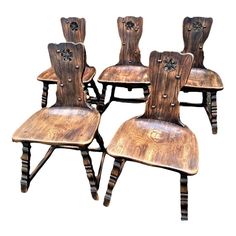 four wooden chairs are sitting side by side