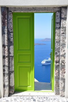 an open green door leading to a boat in the water