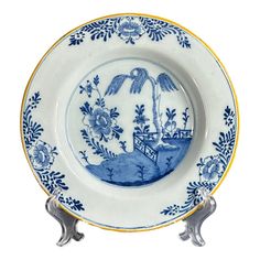 a blue and white plate with an image of a boat in the water on it