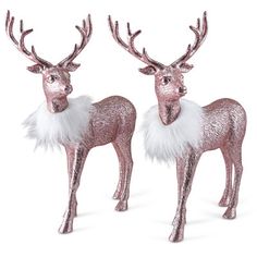 two pink and white reindeer statues with fur on their antlers, one is standing in front of the other