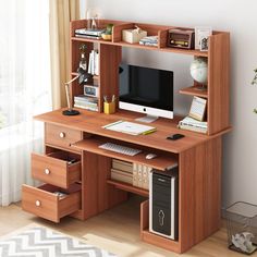 a wooden desk with drawers and a computer monitor