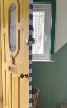 the door is painted yellow and has a blue stripe pattern on it's side