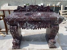 a marble bench sitting on top of a cement floor next to a building under construction