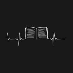 an open book with a heart beat drawn on the side in white ink against a black background