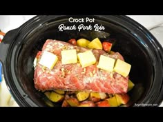 a close up of food in a crock pot with potatoes and meat on it