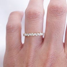 a woman's hand with a diamond ring on it