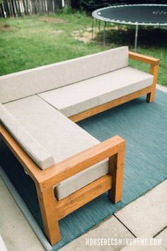 a wooden bench sitting on top of a blue rug