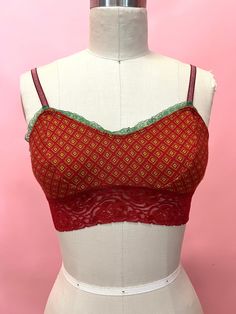 a white mannequin with a red and green top on it's torso