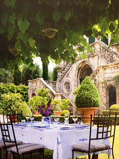 the table is set for two outside in the garden