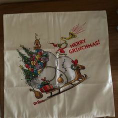 a christmas pillow case with a santa sleigh on it's back and the words merry grinmas