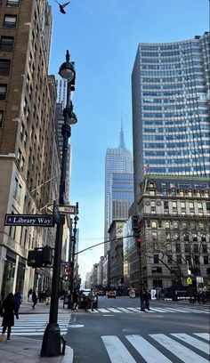 an empty city street with tall buildings in the background