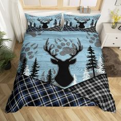 a bed with a deer head and trees on it