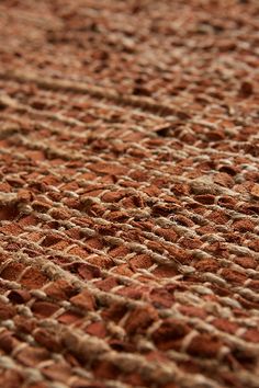 a close up view of the texture of an old carpet with small holes in it