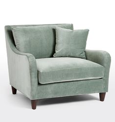 a light green chair with two pillows on the armrests and one seat upholstered