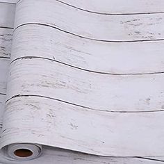 an old white painted wood wallpaper with peeling paint on the bottom and top part