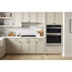 an image of a kitchen setting with white cabinets