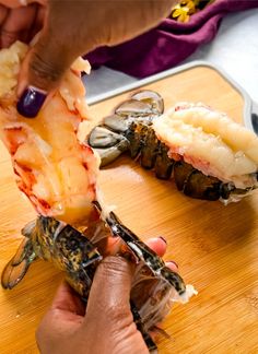 someone is cutting up some food on a wooden table