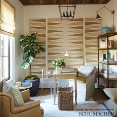 a living room filled with furniture and a potted plant on top of a table