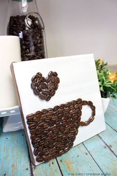 coffee beans in the shape of a heart on a canvas