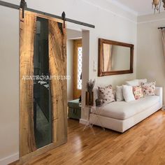 a living room with wood flooring and sliding glass doors that lead into the bedroom