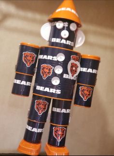 a bear made out of beer cans sitting on top of a table