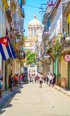 people are walking down the street in an old town