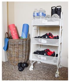 there is a basket with shoes on it next to a shelf filled with sports equipment