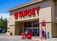 a target store with people walking in front of it and on the side walk, there is a red stop sign