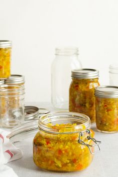 several jars filled with food sitting on top of a table