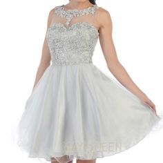 This Is A Silver Dama/Xv Dress That Comes With Both Floral Embroidery And A Rhinestone Sequin. The Sections Carrying Embroidery Are The Upper Chest, Neck, And Upper Back Area. The Upper Chest Area Near The Neck Consists Of A Mesh Design Whilst The Lower Half Of The Dress Has A Tulle. The Dress Is Made Of 100% Polyester And Has Straps. Silver Dama Dresses For Quince Long, Silver Quince Dama Dresses, Silver Quinceanera Dresses Damas, Silver Dama Dresses For Quince Cheap, Dama Dresses Sliver, Elegant Embroidered Dress For Homecoming, Elegant Embroidered Homecoming Dress, Silver Dama Dresses For Quince, Evening Lace Dresses With Rhinestones