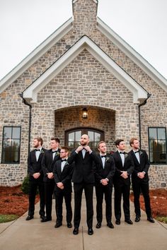 a group of men standing in front of a church