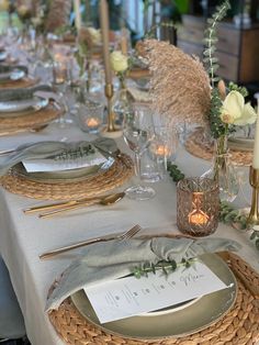 the table is set with silverware and place settings