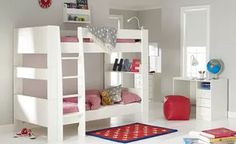 a white bunk bed sitting in a bedroom next to a red rug