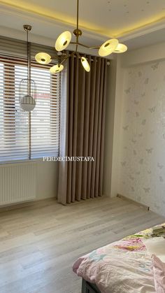 an empty bedroom with wooden floors and curtains