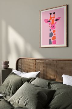 a giraffe print hangs on the wall above a bed with green sheets and pillows