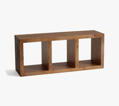 a wooden shelf sitting on top of a white wall