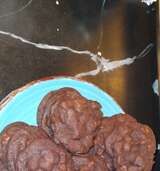 a blue plate topped with chocolate cookies on top of a table