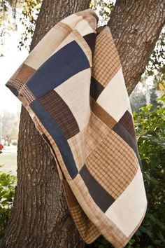 a blanket hanging from the side of a tree