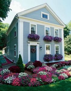 a house with flowers in the front yard