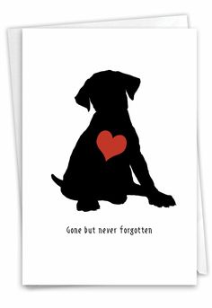 a black dog with a red heart on it's chest sitting in front of a white background