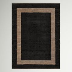 a black and tan rug with a square border