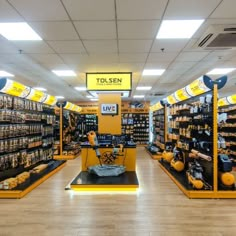 a store filled with lots of shelves and yellow items on display in the middle of the room