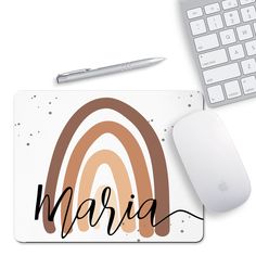 a mouse pad with the word marina on it next to a keyboard and computer mouse