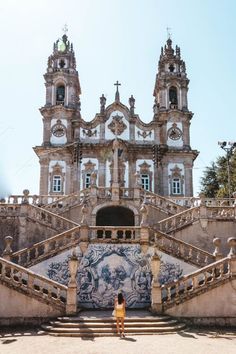 a woman standing in front of an ornate building