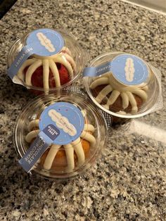 three plastic containers filled with pastries on top of a counter next to a sink