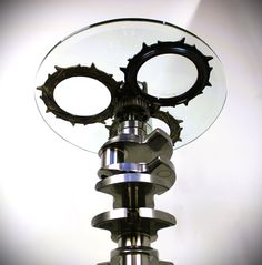 a close up of a metal object with lots of gear on it's sides