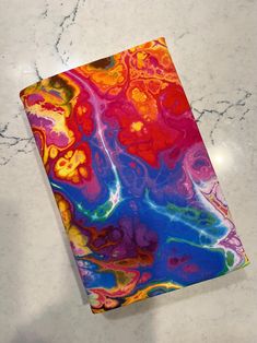 a colorful notebook sitting on top of a white table