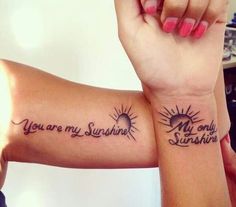 two wrist tattoos with the words you are my sunshine on them